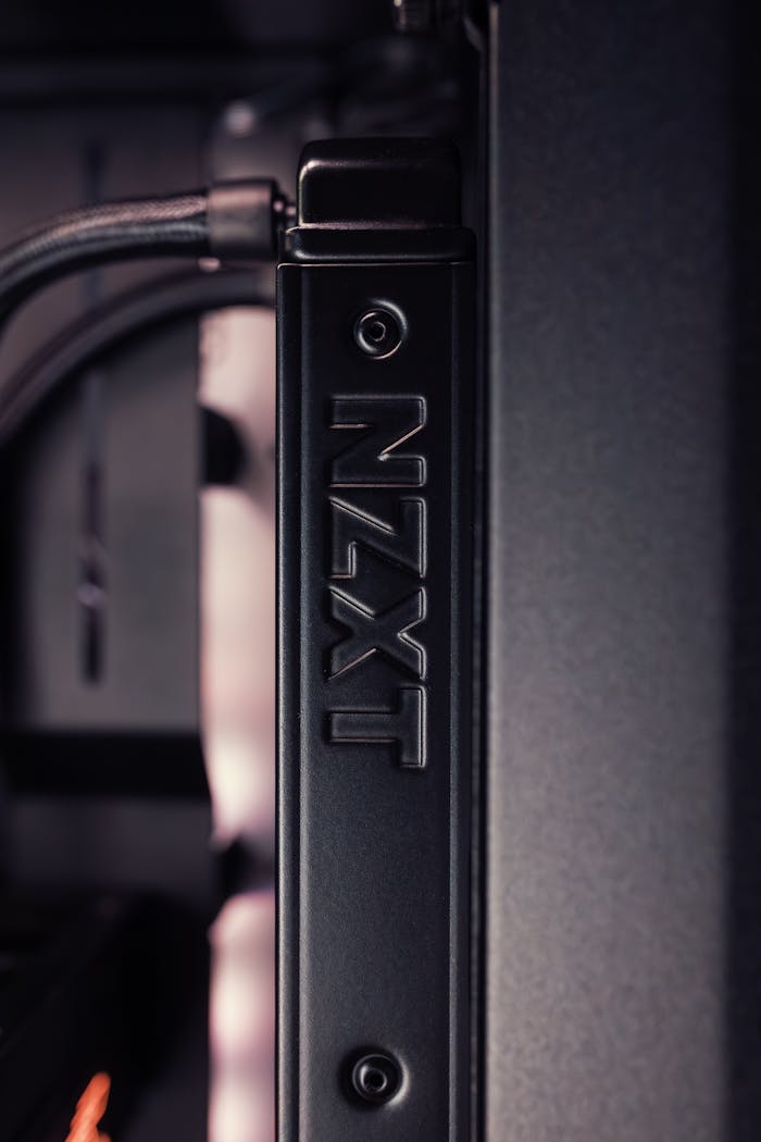 Services Detailed view of a NZXT computer case component with black and gray tones.